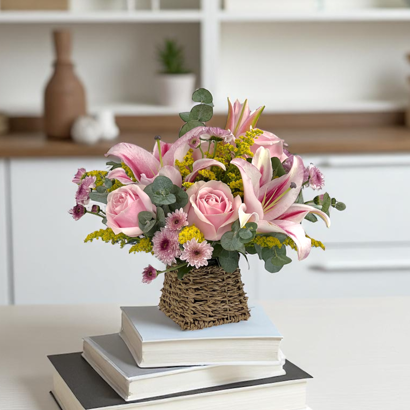 Close-up of Lily Luxe basket featuring pink lilies and roses, a premium fresh flower gift with elegant design.