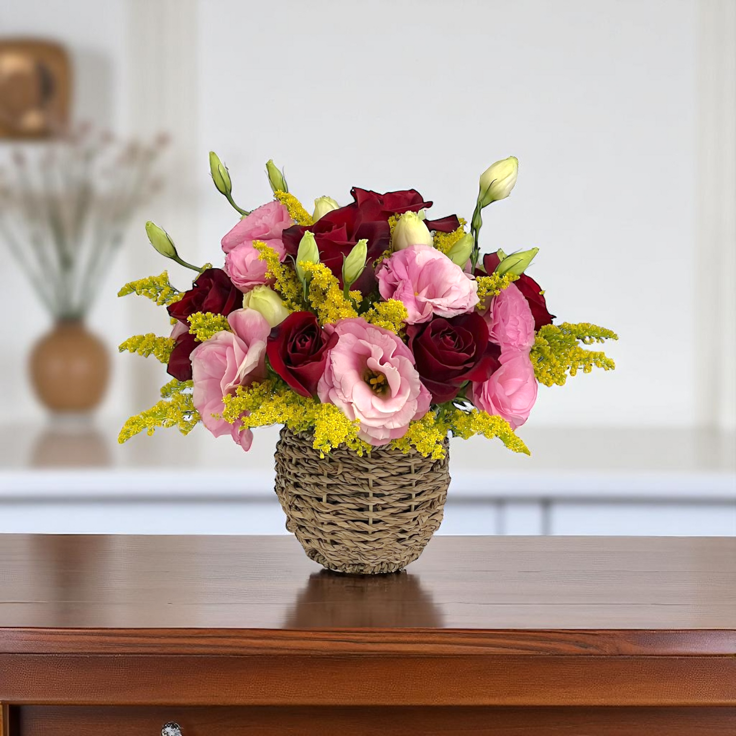 Front view of Rosy Romance flower basket with red roses and pink eustoma, arranged in a compact romantic gift basket.