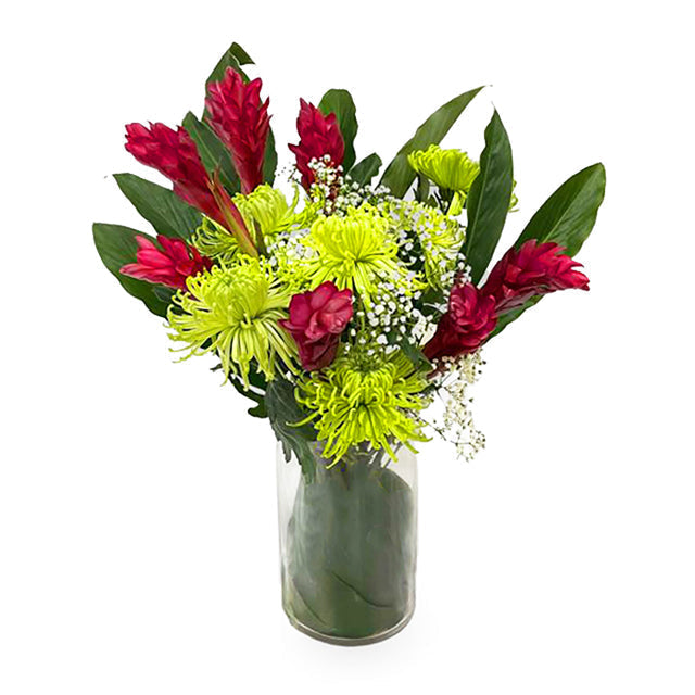 Red and green tropical flower arrangement in glass vase