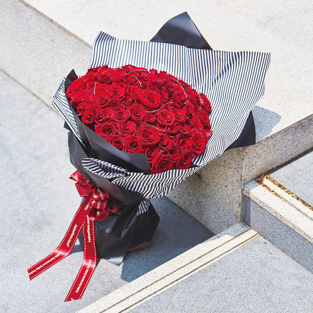 Big 99 Red Roses Bouquet with black wrapping and fairies light perfect for anniversaries