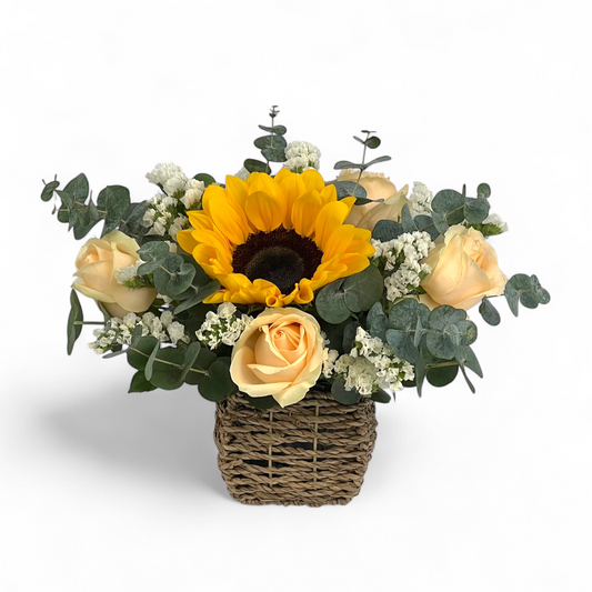 Close-up of Golden Shine flower arrangement featuring fresh sunflowers and peach roses in a small basket, perfect as a cheerful flower gift.