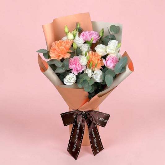 Bouquet of flowers with a brown ribbon on a pink background